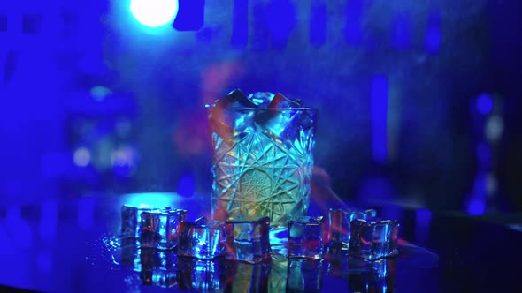 Bartender Sets Fire to Alcohol Cocktail Blue Background