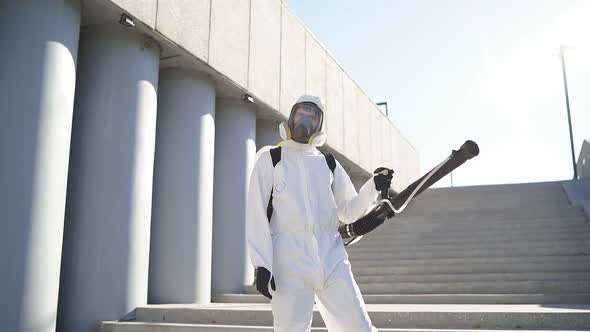 Young Sanitation Worker in Hazmat with Pressure Washer Outdoors