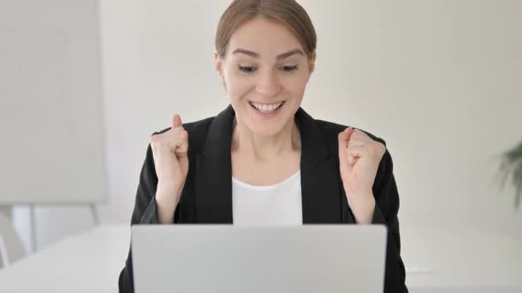 Close Up of Young Businesswoman Celebrating Success on Laptop