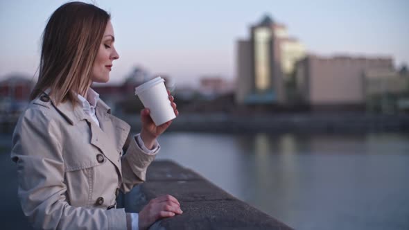 Woman Walking on Riverside in City