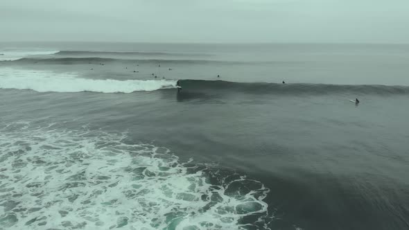 Aerial closing on expert surfer riding amazing wave, Pichilemu, Chile-4K