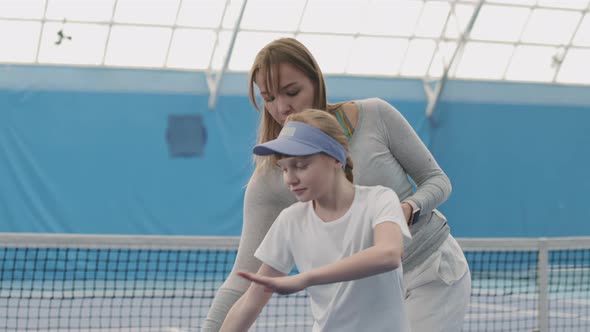 Little Girl Practicing Tennis With Coach