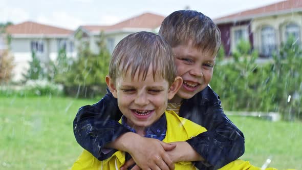 Happy Brothers Hugging in Rain