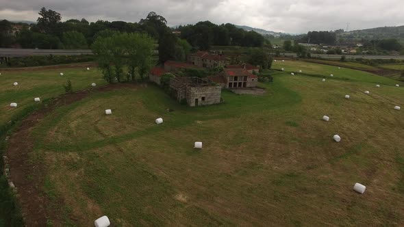 Field with haystacks. Haystacks on sloping field