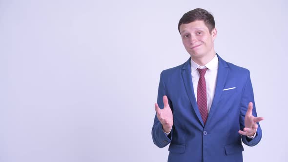 Happy Young Businessman Touching Something with Surprise Gesture
