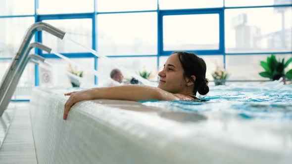 Young Woman Relaxing in the Pool is Enjoying Closeup Shot