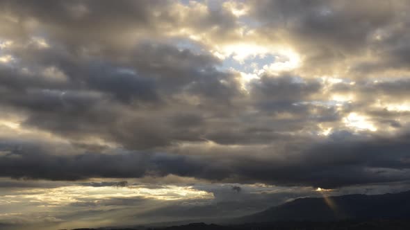 Sunbeams shining through heavy clouds