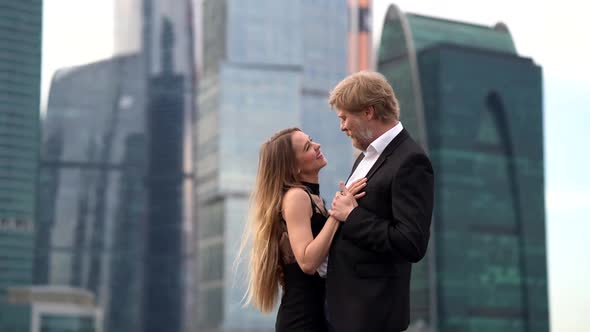 Loving Pair in Modern City, Embracing and Laughing at Background of Skyscrapers