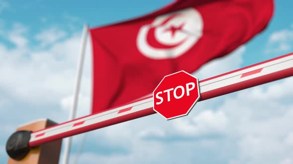 Opening Barrier with Stop Sign Against the Tunisian Flag alt