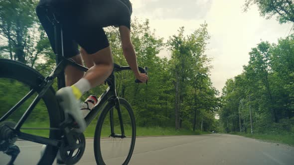 Cyclist Riding On Carbon Bike In Lycra Sportswear. Muscular Fitness Biker Cycling Workout.