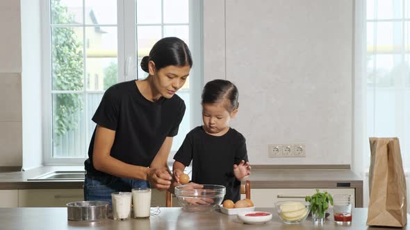 Woman and Little Girl in the Kitchen