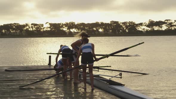 Female rowing team training on a river