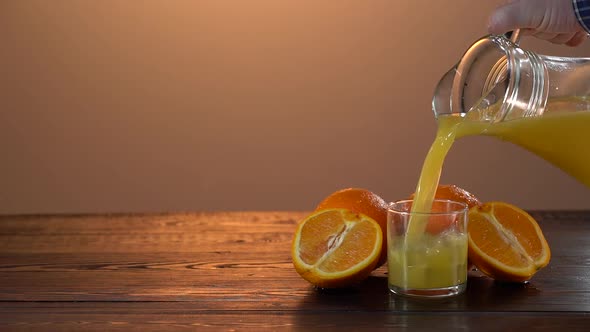 Super Slow Motion Shot of Pouring Fresh Orange Juice Into Glass