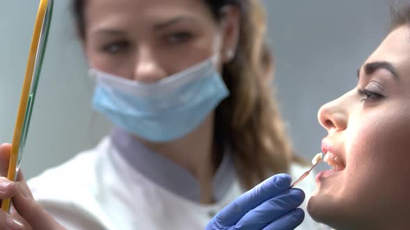 Dental Patient Looking Into Mirror.