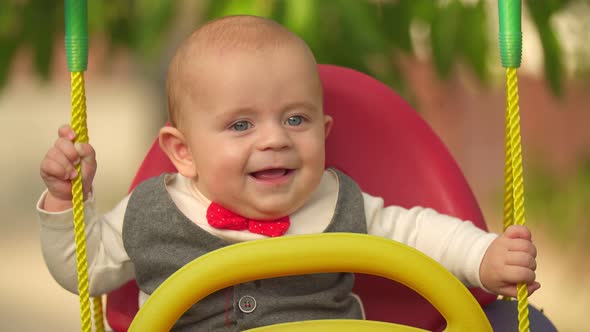 Little Kid Riding a Swing