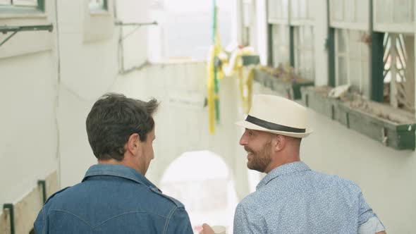 Back View of Homosexul Male Couple Going Down Stairs in Street