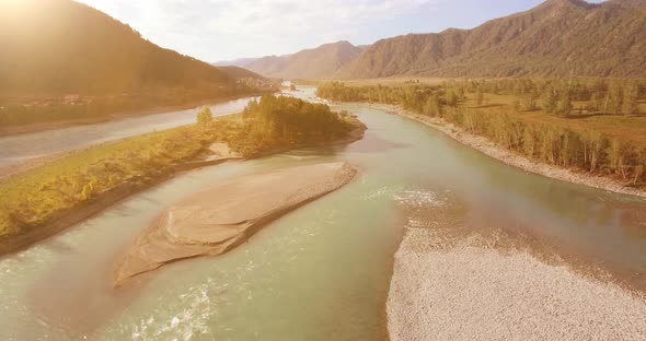 Low Altitude Flight Over Fresh Fast Mountain River with Rocks at Sunny Summer Morning.