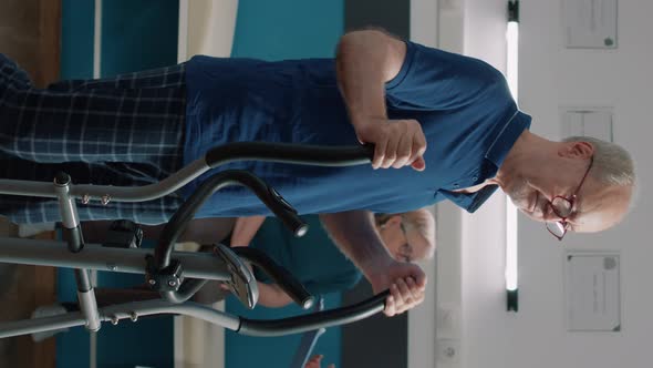 Vertical Video Portrait of Senior Patient Using Stationary Bicycle for Recovery Program