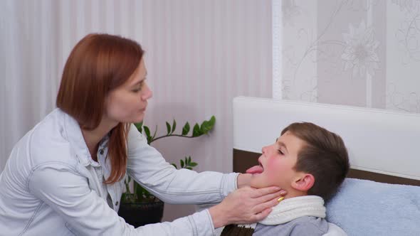 Mother Examines Unhealthy Condition of Male Child Measures Temperature with Noncontact Thermometer