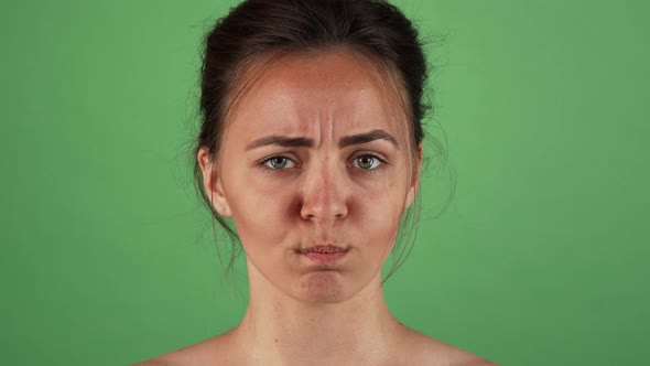 Beautiful Woman Looking Doubtful Posing on Green Background