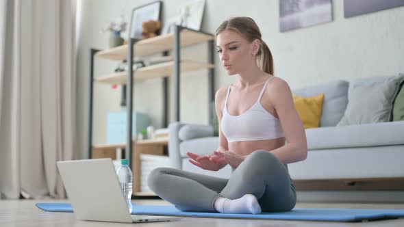 Woman Doing Video Call on Laptop While on Yoga Mat