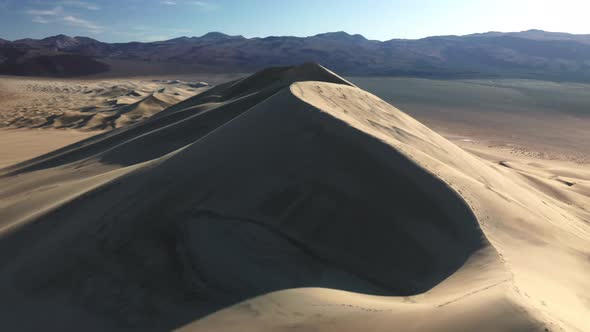 Drone Flying Above Sand Dune with Scenic Pattern and Texture in Sunset Light