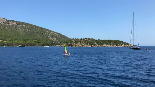 Boat in the sea, beach, people, and a nice sunny and hot summer day