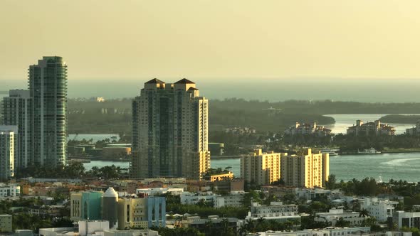 Aerial Panning Shot Miami Beach Coastal Condo Buildings By Inlet. 7x Telephoto Zoom Lens Shot