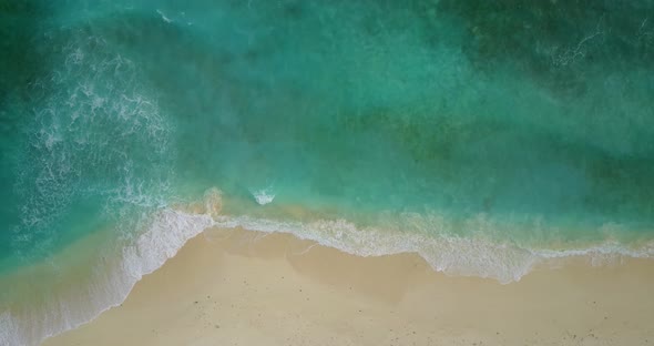 Beautiful overhead island view of a paradise sunny white sand beach and aqua turquoise water backgro