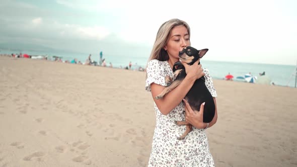 Small Dog Named Artur with Owner, Young Woman, Playing on the Beach