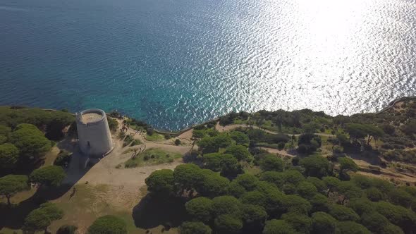 Aerial view of a lighthouse on the top of a cliff in the mediterranean coast of Spain.