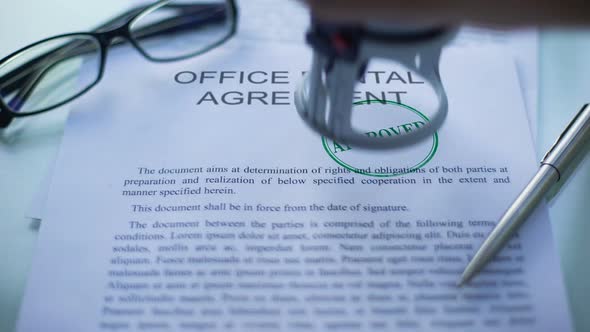 Office Rental Agreement Approved, Hand Stamping Seal on Business Document, Close