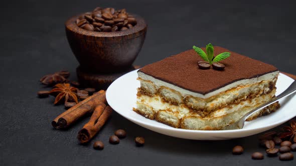 Portion of Traditional Italian Tiramisu dessert and coffee beans