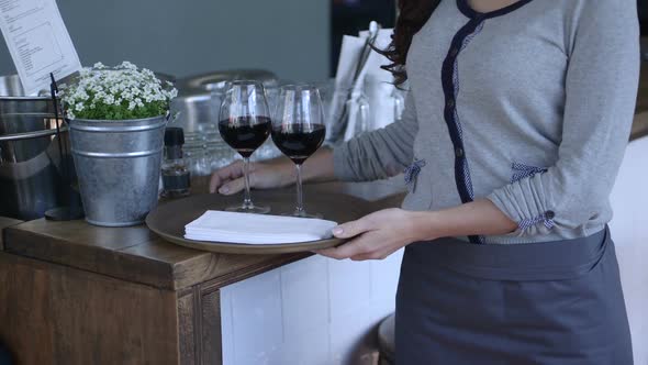 MS TU Waitress holding wine glass and looking at camera / Breda, NoordBrabant, Netherlands.