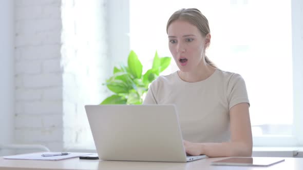 Woman Reacting to Financial Loss While Using Laptop