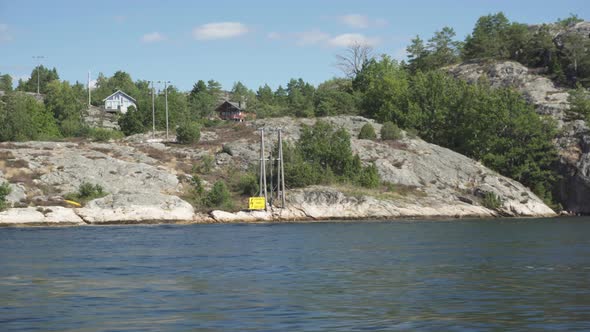 Remote Norwegian island, viewed from boat on water