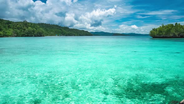 Beautiful Blue Lagoon with Pure Clear Water and Rainy Clouds in Background, Gam Island, West Papua