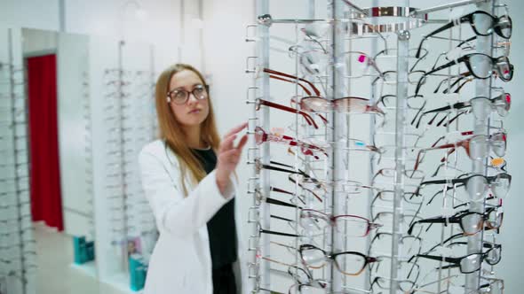 Woman in optometrist store. Young woman with eyeglasses in optical store