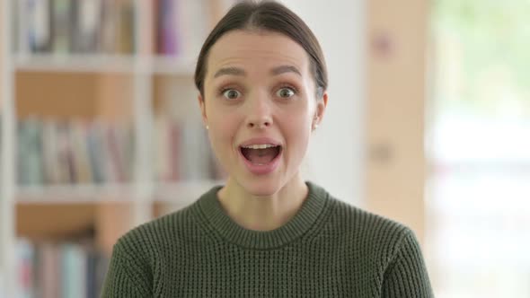 Portrait of Surprised Happy Young Woman Astonished