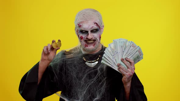 Creepy Man with Bloody Scars Face Halloween Zombie Showing Golden Bitcoins Mining Future Technology