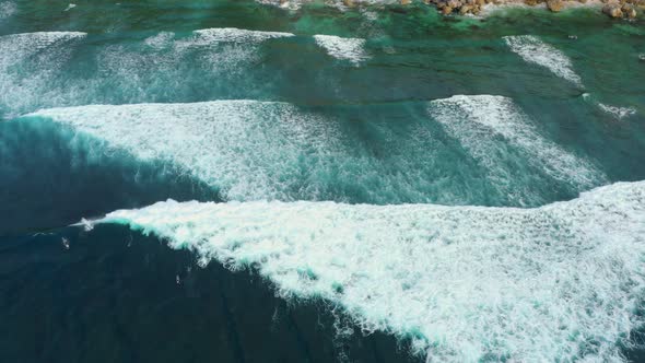 Aerial Top Down View of Giant Ocean Waves Crashing and Foaming