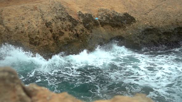 The Waves Beat Against the Rocks. Storm on the Mediterranean Sea. The Sea Is Turquoise. Slow Motion.