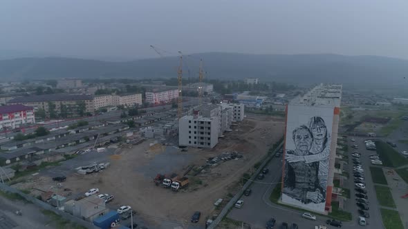 A picture "great-grandmother and granddaughter" is painted on building in city