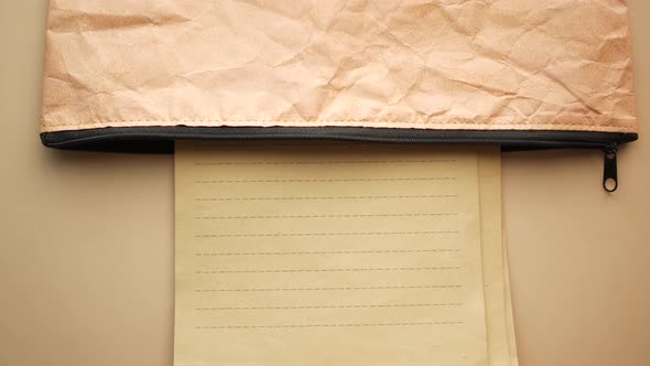 Putting Paper in a Bag on Table alt