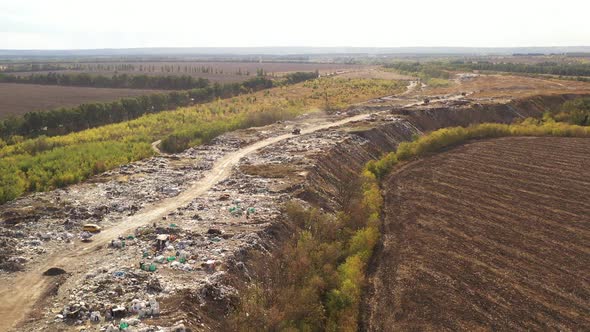 Aerial View of Trucks Bringing Waste To a Garbage Pile in Trash Dump. Large Garbage Pile at Sorting