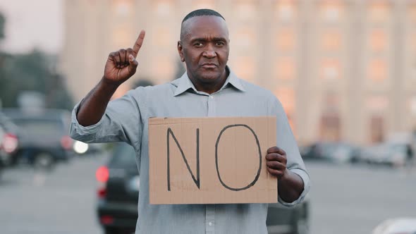 Black Immigrant Person Holding Cardboard Slogan Banner with Text No African American Man Standing in