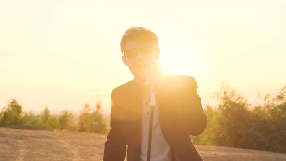 Bearded Rock Star Singer with Black Glasses Sing Expressive Song in Retro Microphone