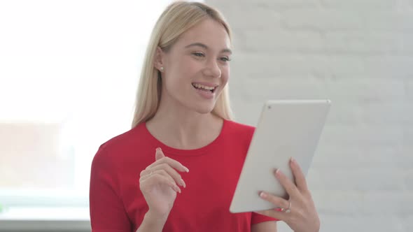 Portrait of Video Call on Tablet by Young Blonde Woman in Office