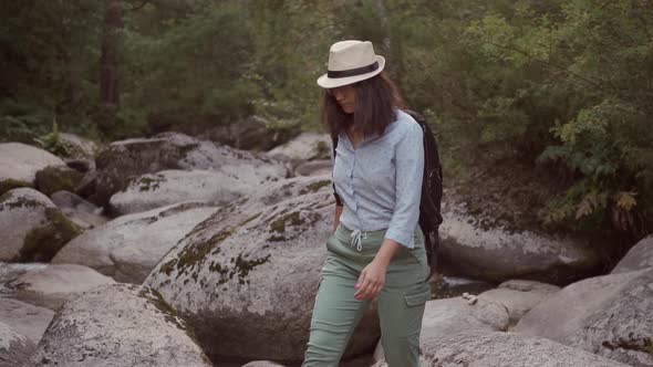 Woman Traveler Walks on Huge Stones in Nature