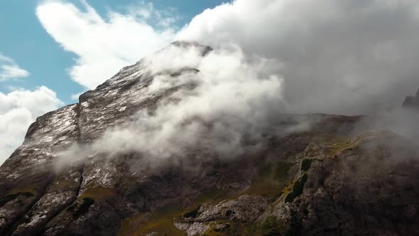 Dolomite mountain peak in northern Italy with moisture forming a cloud during the winter season, Aer